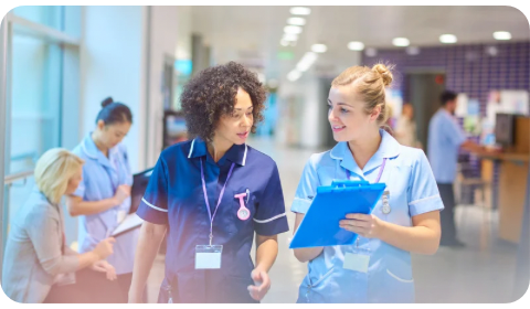 Photo of a doctor and nurse talking in the corridor of a hospital in the UK.